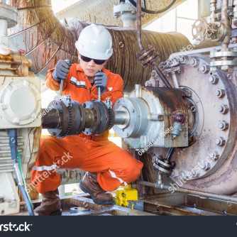 stock-photo-mechanical-inspector-inspection-and-re-alignment-oil-pump-centrifugal-type-and-electric-motor-749946151